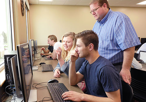 Students and faculty interact in the Communications Lab