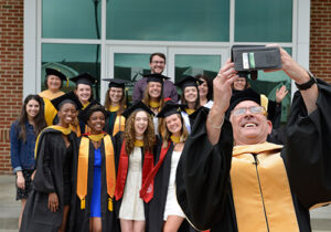 Graduates pose for a group photo.