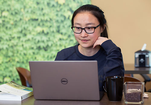 An international student fills out an online application