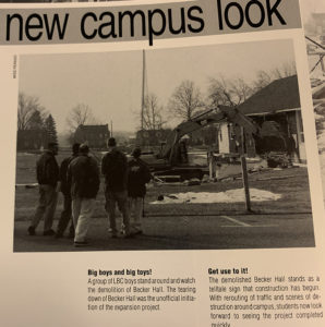 A group of students watches the demolition of Becker Hall, which was torn down to make room for Good Shepherd Chapel.