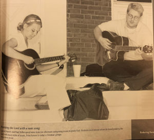 Two students, Laurie Snavely and Paul Miller, play their guitars outside of their dormitory in 1999.
