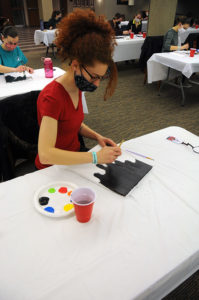 Students painting at new art club.