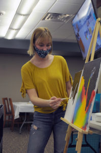Students painting at new art club