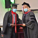 A graduate receiving their degree.