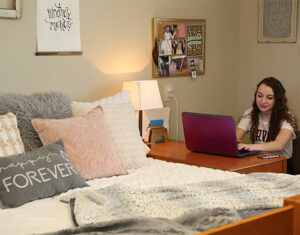 LBC student studying in her dorm.