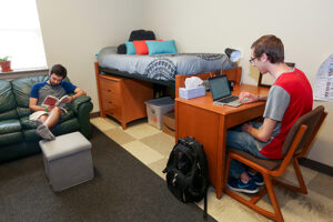 Students studying in their dorm room.