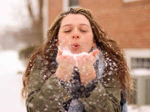 A woman playing with snow. 