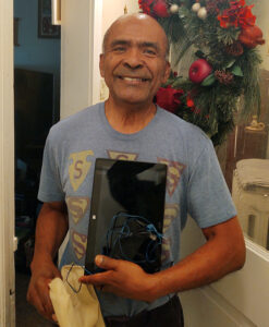 Pastor Alberto prepares to take a donated tablet on a journey from Lancaster to Ecuador. 