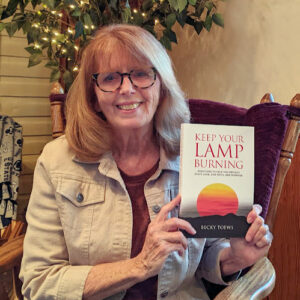 Professor Becky Toews with her book