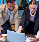 business professor showing a student something on the computer