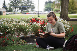 student reading under tree