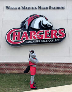LBC charger mascot, bolt, in front of stadium.