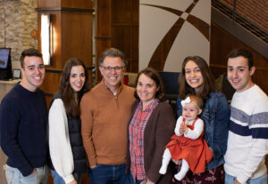 From left, Caleb, Hannah, Mark, Gina, Stephanie (holding Sara Grace) and Joshua Brussel.