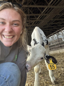 A selfie with a calf is just one stop along a busy day as a dairy farmhand for Sarah Dukeman.