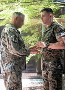 chaplain prays with soldier