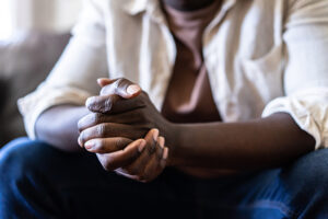 a young man praying with folded hands