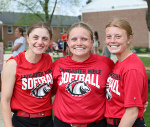 three LBC softball players